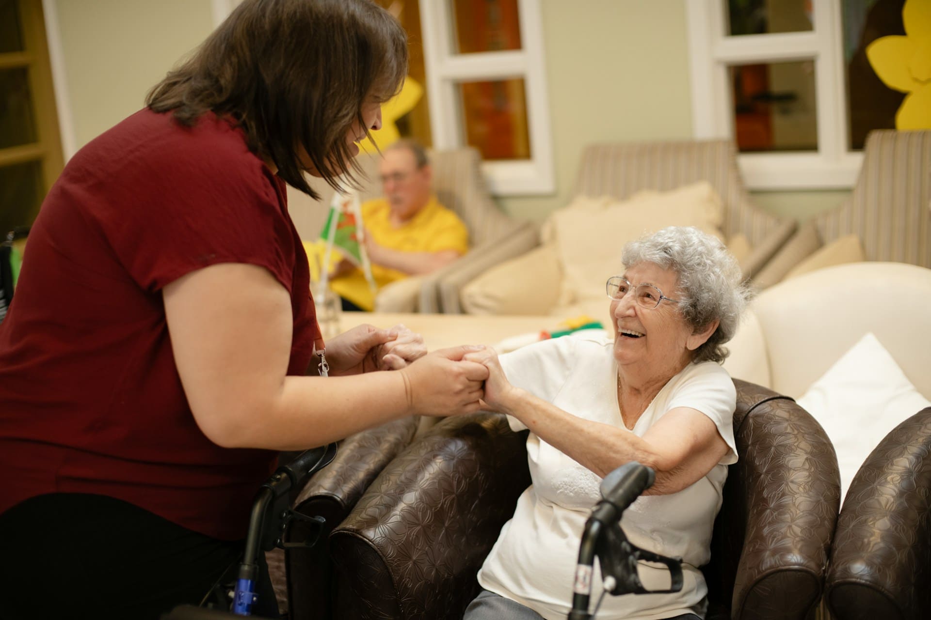 Senior woman with a health visitor sitting at the table at home